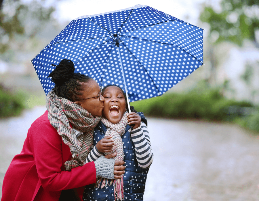 Mother and daughter under an umbrella